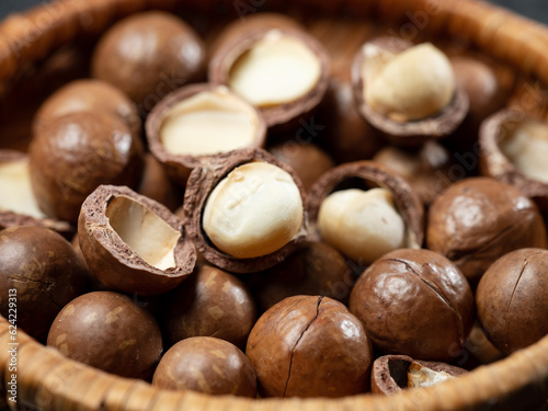 Roasted macadamia nuts on wooden background