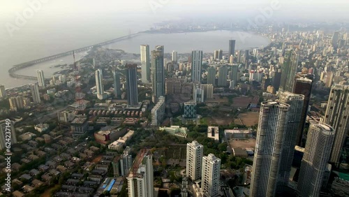 Aerial footage of city scape over business district of Mumbai with Bandra Worli Sealink in view. Greater Mumbai drone footage. Drone shot of downtown Mumbai with a seaface view