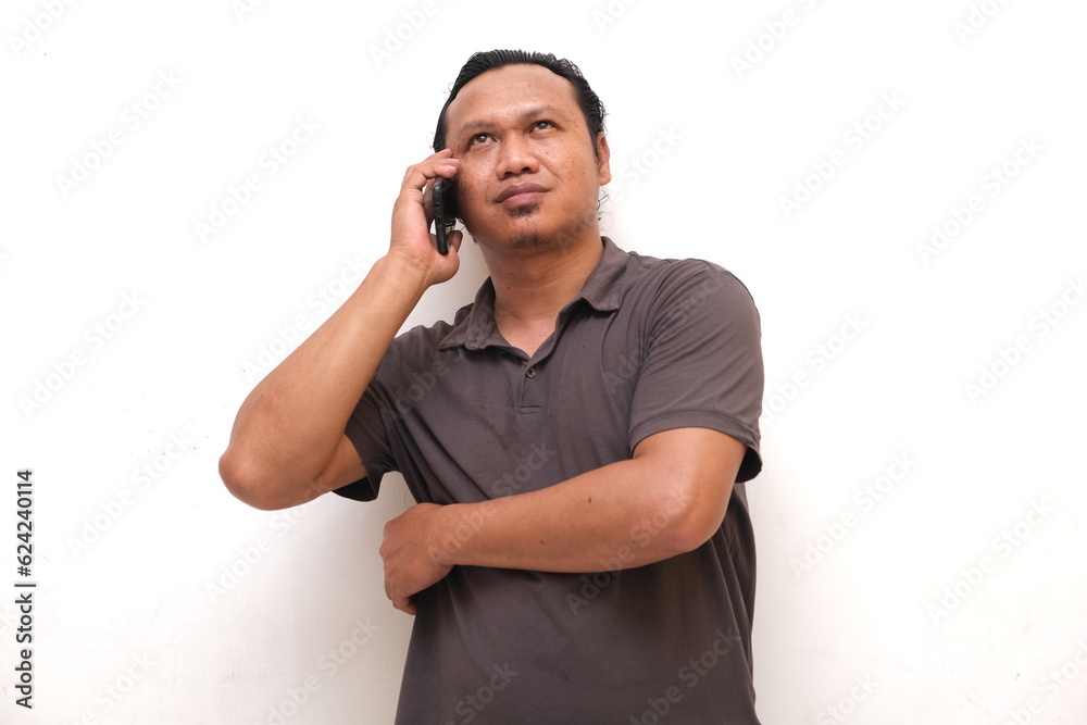 confident asian man is communicating using mobile phone