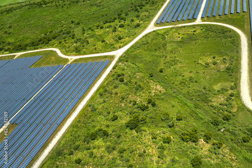 Aerial view of big sustainable electric power plant with many rows of solar photovoltaic panels for producing clean electrical energy. Renewable electricity with zero emission concept