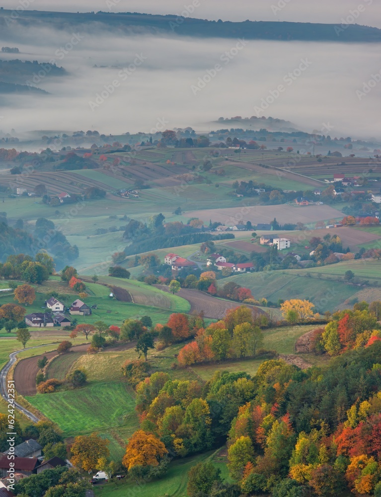 Fall landscape in Slovakia. Rural countryside in Polana region. Fields and meadows with autumn trees in Hrinova at sunrise.