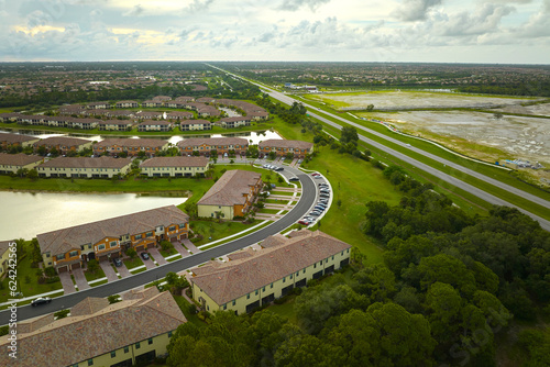 Aerial view of tightly located family houses in Florida closed suburban area. Real estate development in american suburbs