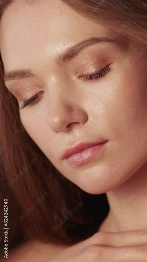Vertical video. Skin hair wellness. Care procedure. Natural beauty skincare. Attractive playful young woman with smooth perfect radiant face nude makeup. Vertical video. Skin hair wellness. Care procedure. Natural beauty skincare. Attractive playful young woman with smooth perfect radiant face nude makeup.