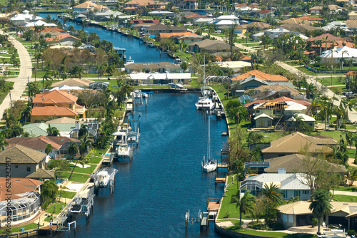 Destroyed by hurricane Ian suburban coastal houses in Florida home residential area. Consequences of natural disaster photo