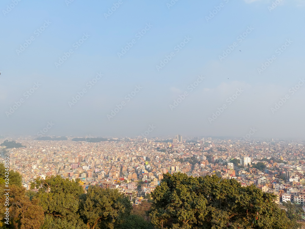 Fototapeta premium View of the Kathmandu city from the top of the Syambhunath temple, showing the congested buildings with some trees. Kathmandu city