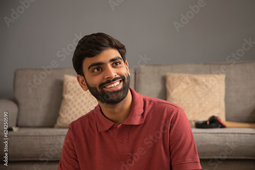 Portrait of cheerful young man looking away