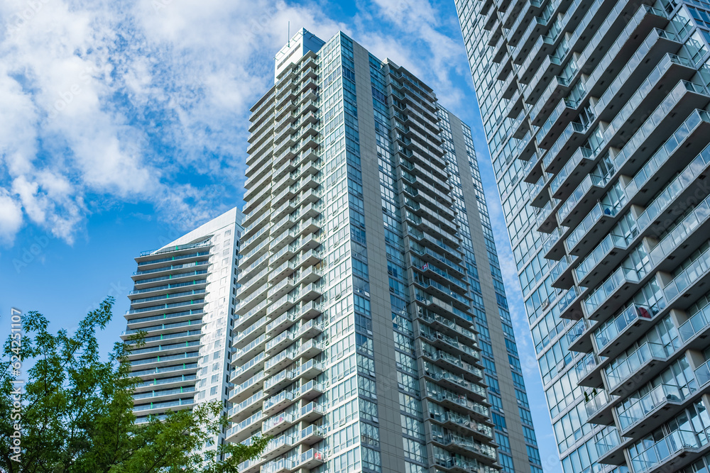 New block of modern apartments with balconies and blue sky in the background. View of an apartment complex in Surrey BC