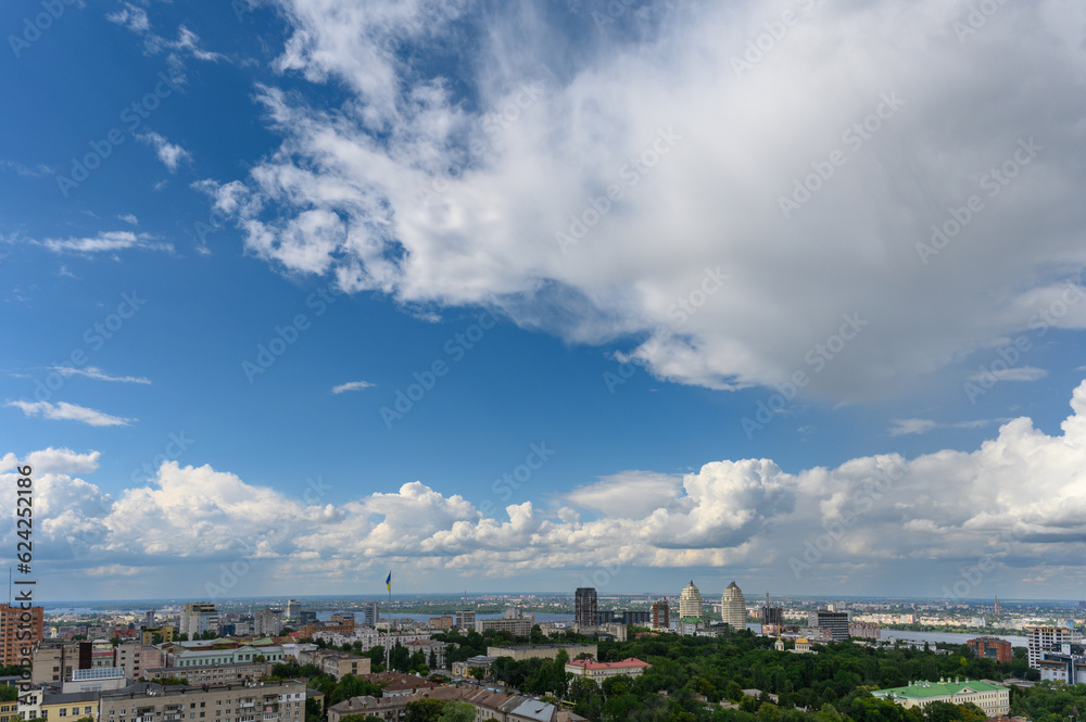 Beautiful cumulus clouds in the blue sky over the city. Beautiful cumulus clouds in the blue sky over the city.