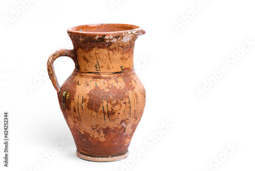 Antique earthenware jug with damaged paint on the surface.