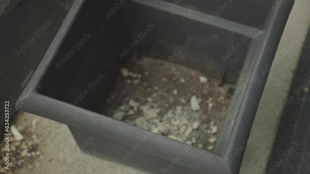 Hand In Gloves Placing Soil And Stones For Large Planter. High Angle Hand In Gloves Placing Soil And Stones For Large Planter. High Angle