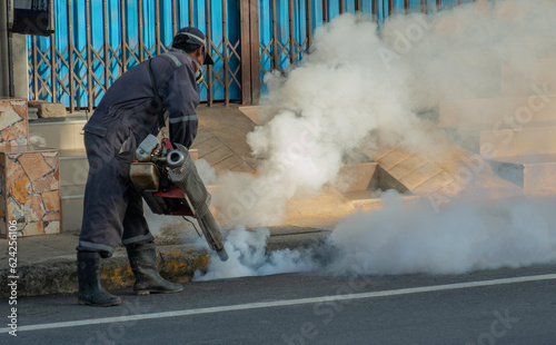 Фотография worker fogging mosquito to prevent of dengue fever