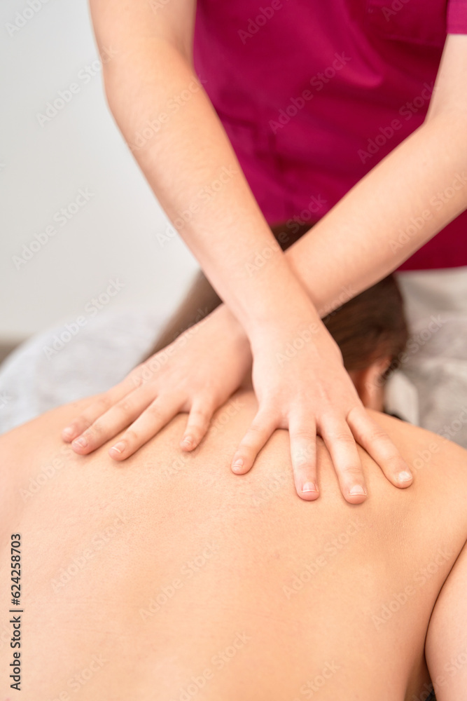Anonymous Physical Therapist Administers Treatment on Patient's Back Anonymous Physical Therapist Administers Treatment on Patient's Back