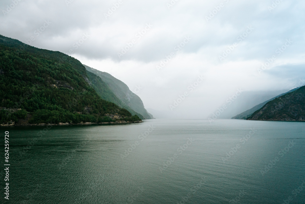 Misty morning sailing through the Hardangerfjord on a cruise ship Misty morning sailing through the Hardangerfjord on a cruise ship