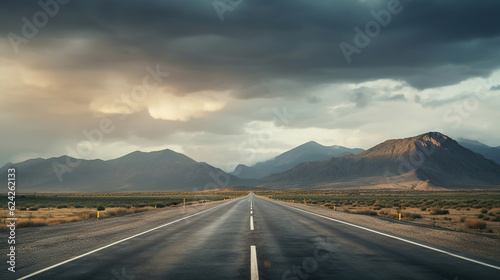 A Lonely Road Towards the Horizon Amid Moody Storm Clouds Over Mountains