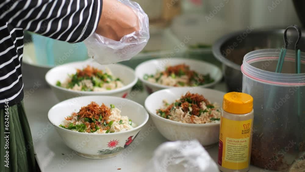 Chicken porridge seller or tukang bubur ayam is prepares his meal for customers or pelanggan. Bubur Ayam (Chicken Porridge), Malaysian Traditional FooChicked Consist of White rice porridge with salted