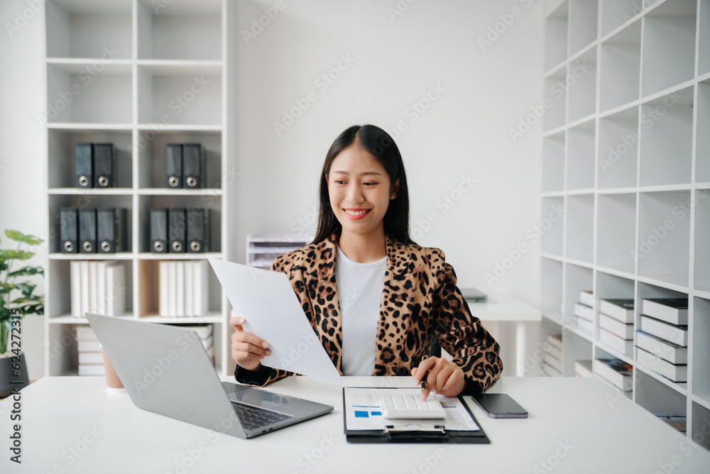 Business woman using tablet and laptop for doing math finance on an office desk, tax, report, accounting, statistics, and analytical research concept in office Business woman using tablet and laptop for doing math finance on an office desk, tax, report, accounting, statistics, and analytical research concept in office