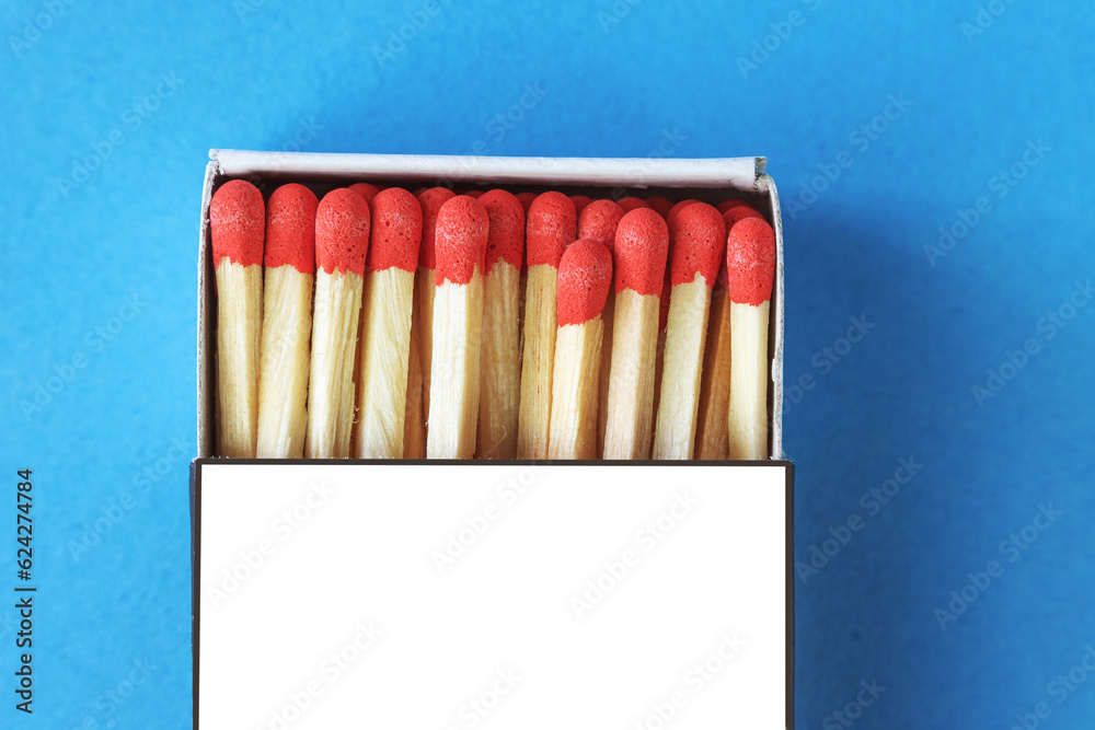 Matchbox with red match heads on a blue background Matchbox with red match heads on a blue background