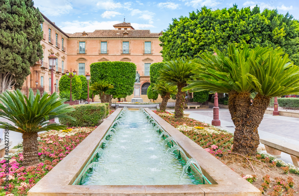 Fototapeta premium Palm trees, flowers and fountain on the glorieta de espana square in Murcia, Spain