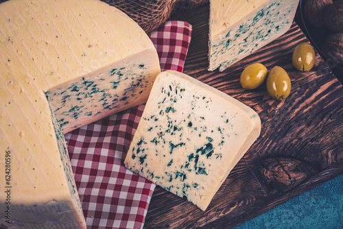 Cheese collection, piece of gorgonzola cheese with blue mold close up photo