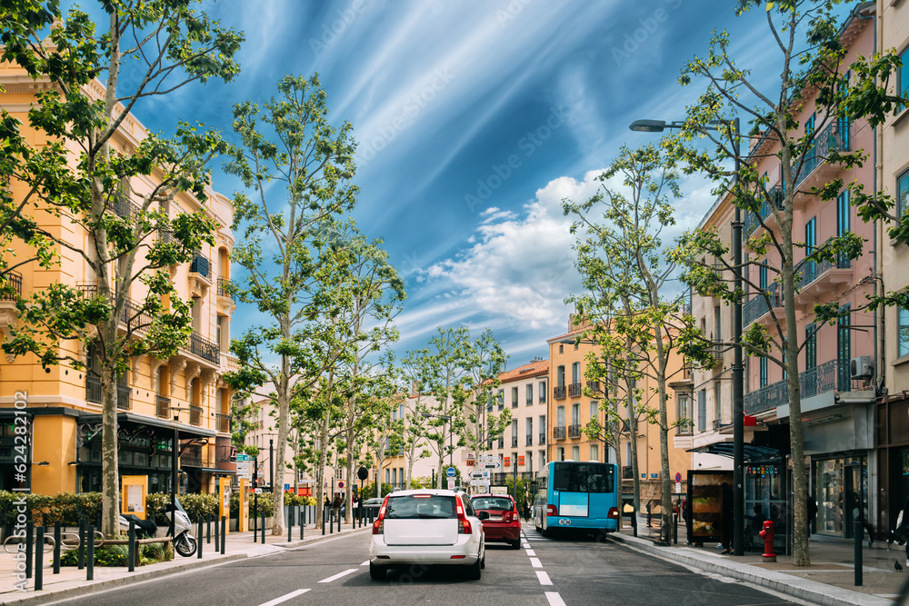 Perpignan, France. Traffic Near Bus Stop On Place Jean Payra In Sunny Spring Day