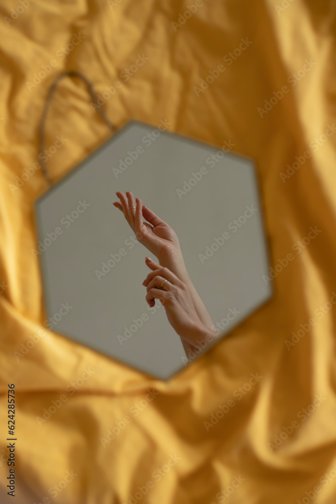 Female hands are reflected in the mirror Female hands are reflected in the mirror