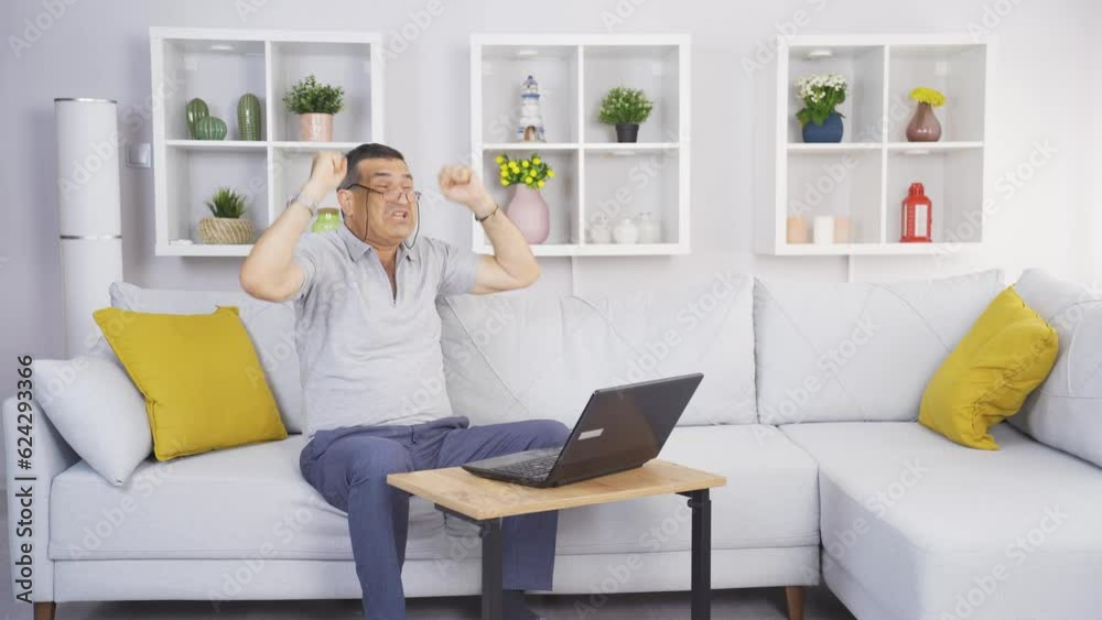 The old man looking at the laptop rejoices. The old man looking at the laptop rejoices.
