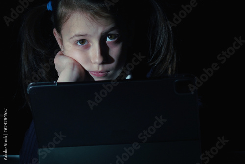 Lack of sleep as a result of studying at night may impair children's mood, increase stress and anxiety levels and decreased cognitive abilities. Young girl studies online at night
