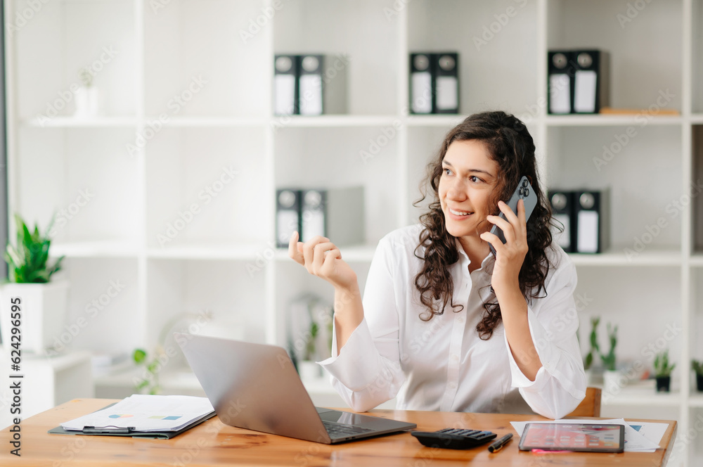 Happy business woman have the joy of talking on the smartphone, tablet and laptopon the office Happy business woman have the joy of talking on the smartphone, tablet and laptopon the office