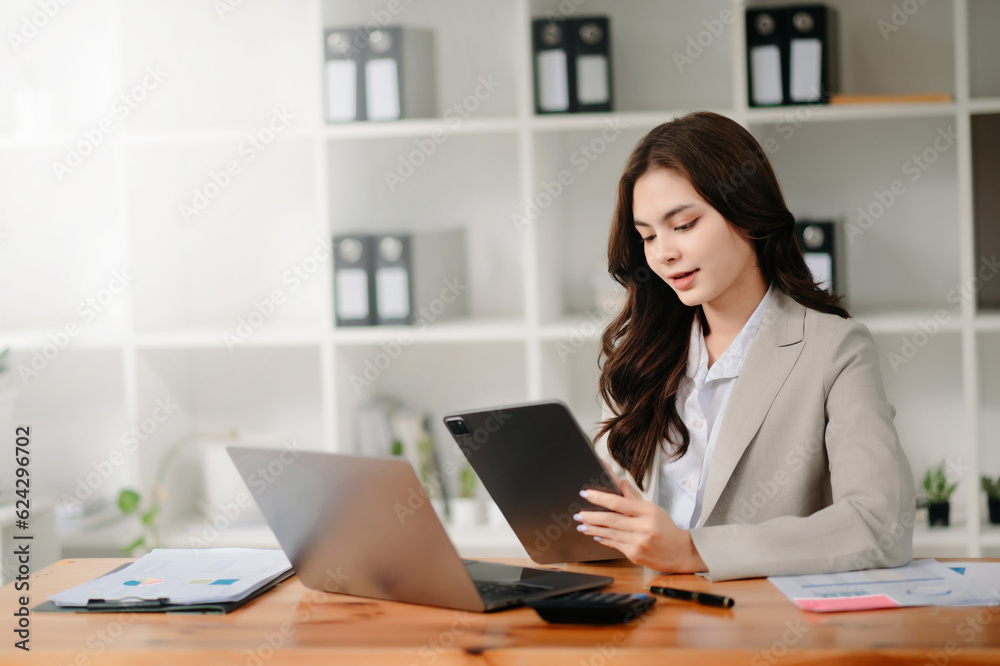 Working woman concept a female manager attending video conference and holding tablet, smatrphone and cup of coffee Working woman concept a female manager attending video conference and holding tablet, smatrphone and cup of coffee
