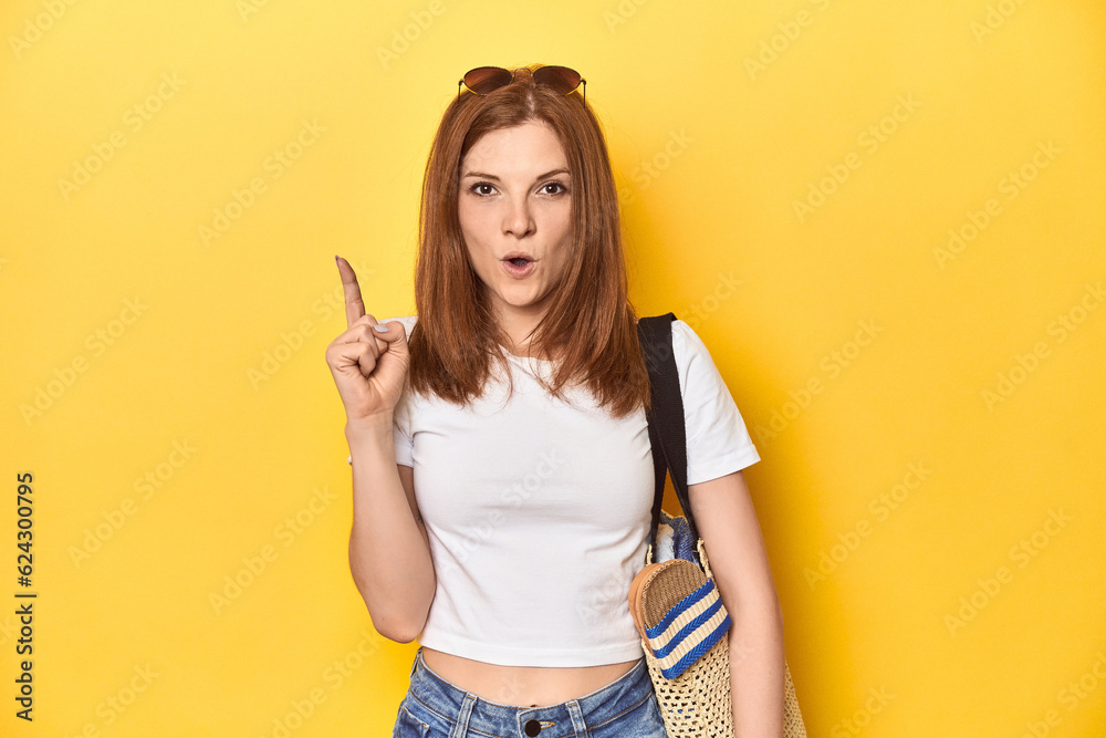 Summer concept redhead with beach bag in studio having some great idea, concept of creativity. Summer concept redhead with beach bag in studio having some great idea, concept of creativity.