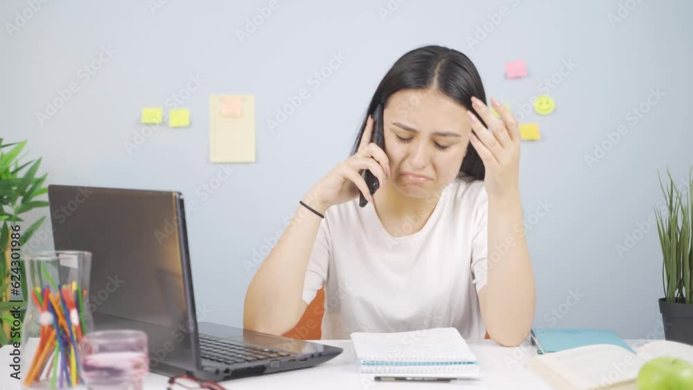 Female student receiving bad news on the phone. Female student receiving bad news on the phone.