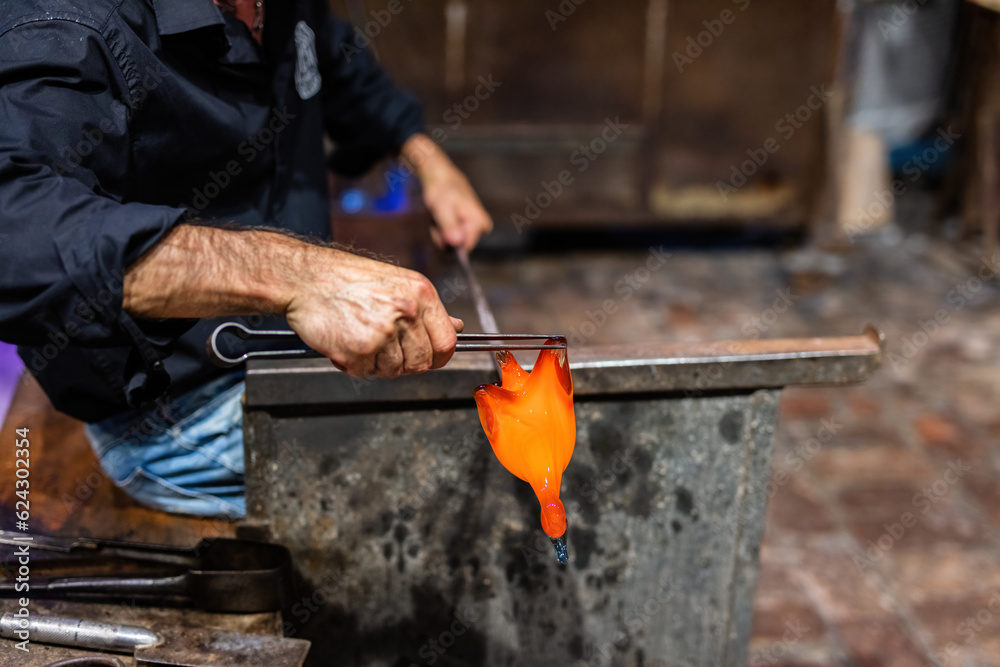 Glass blower at work in workshop in Murano, Italy Glass blower at work in workshop in Murano, Italy