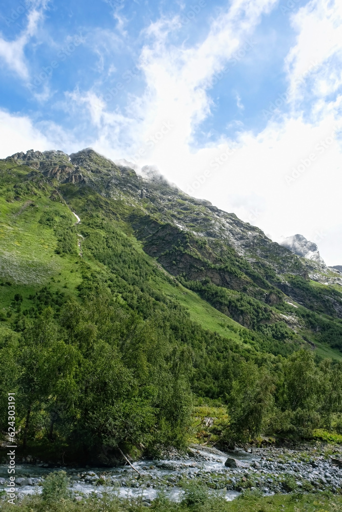 Summer landscape with greats green mountains against cloudy sky. beautiful scenic nature view with mountains. natural background. trip, journey, hiking, adventure concept. Caucasus mountains, Arkhyz