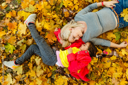 happy family mother and child daughter playing and laughing on autumn walk.