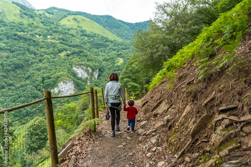 Mother and son on a trail in the Borce commune of the French Pyrenees and its beautiful mountains photo