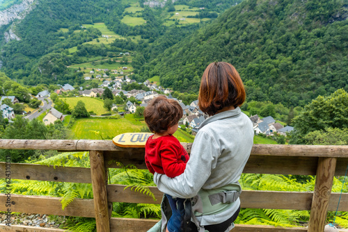 Mother and son on a trail having fun in a Borce commune in the French Pyrenees and its beautiful mountains photo