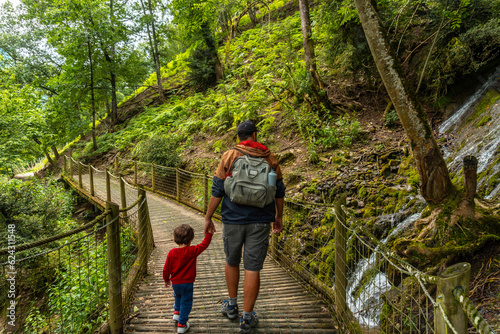 Father and son on a mountain trail in the Borce commune of the French Pyrenees photo