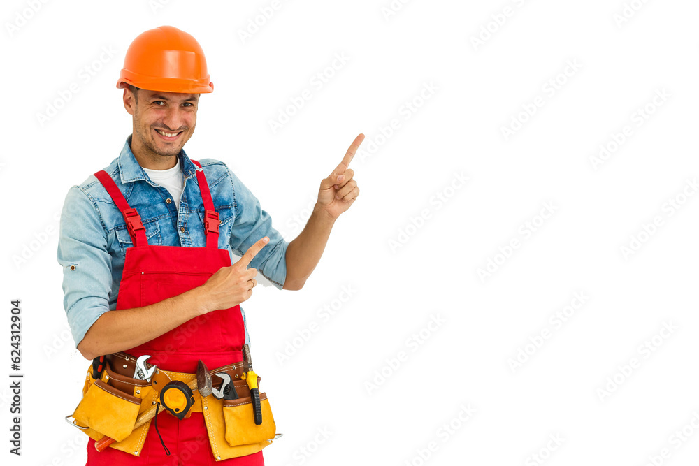 Cheerful male contractor wearing helmet isolated on white background pointing aside while looking at camera