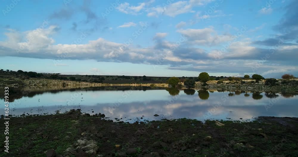 drone shot - flying over a beutiful colorful lake . the clouds are reflected on the water 2 drone shot - flying over a beutiful colorful lake . the clouds are reflected on the water 2