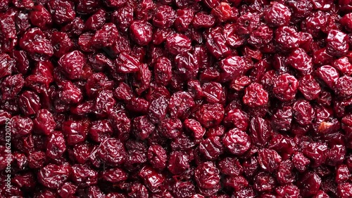 Dry red pitted cherries in the background, close up, top view, rotating. A way to preserve vitamins. Vegetarian meal, healthy and useful