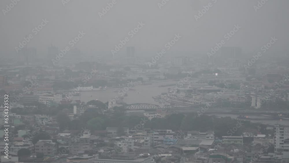 The cityscape of Bangkok is obscured by a thick blanket of dust and