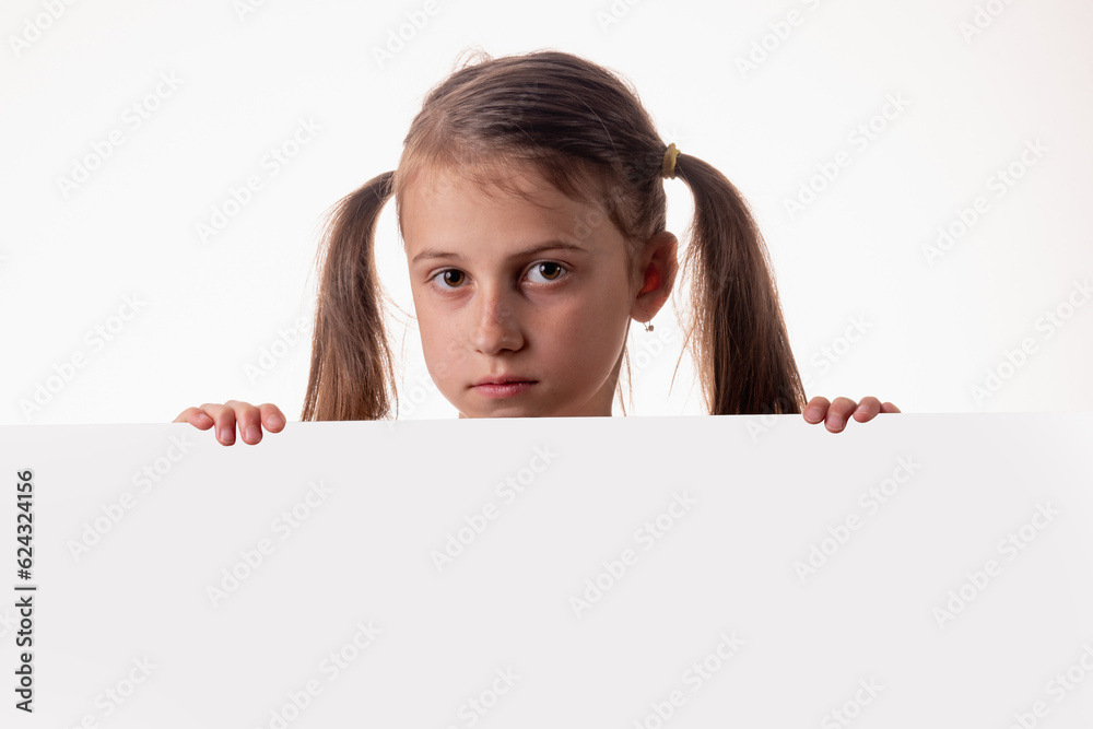 Young girl behind white blank banner or empty copy space advertisement board on brown background, Copy space. Young girl behind white blank banner or empty copy space advertisement board on brown background, Copy space.