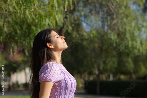 Profile of a relaxed woman in a park breathing