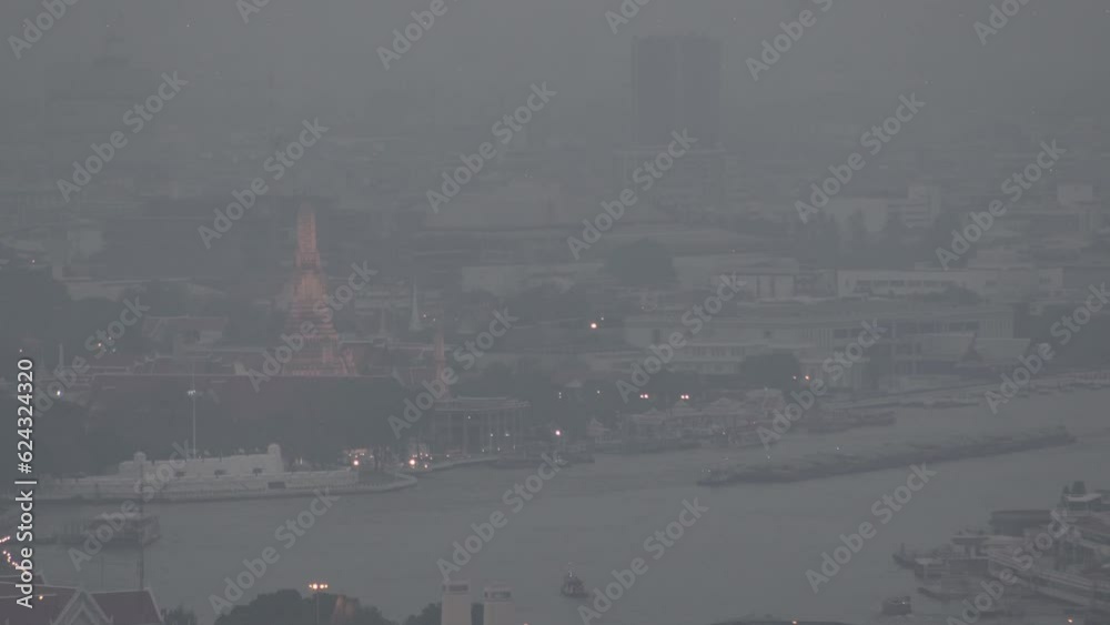 The cityscape of Bangkok is obscured by a thick blanket of dust and