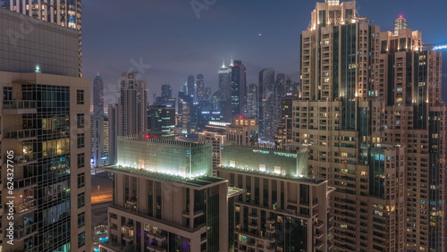 Dubai skyscrapers with golden sky over business bay district day to night timelapse.