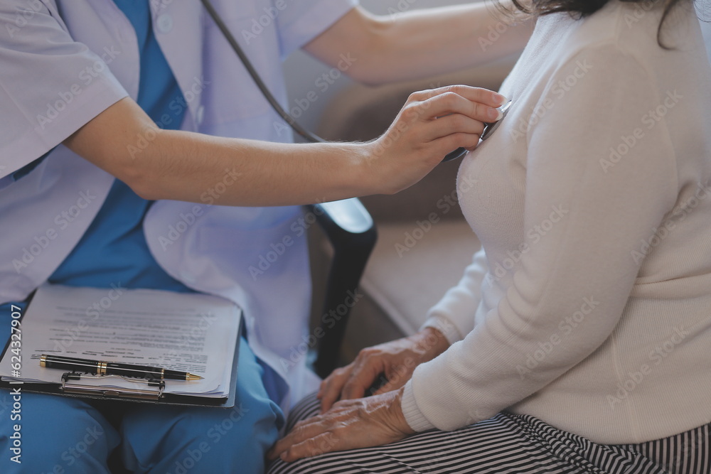 Close up of Doctor using stethoscope to exam heart and lungs of patient woman.