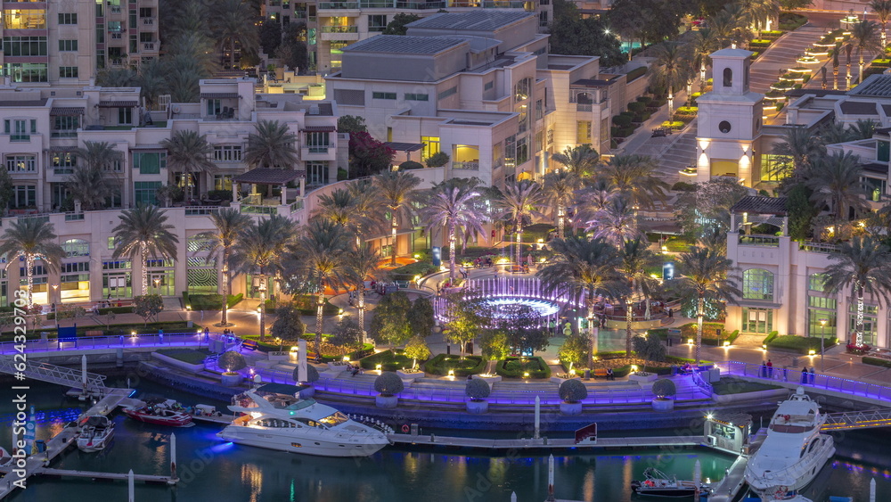 Picturesque fountain on Dubai Marina promenade aerial day to night timelapse
