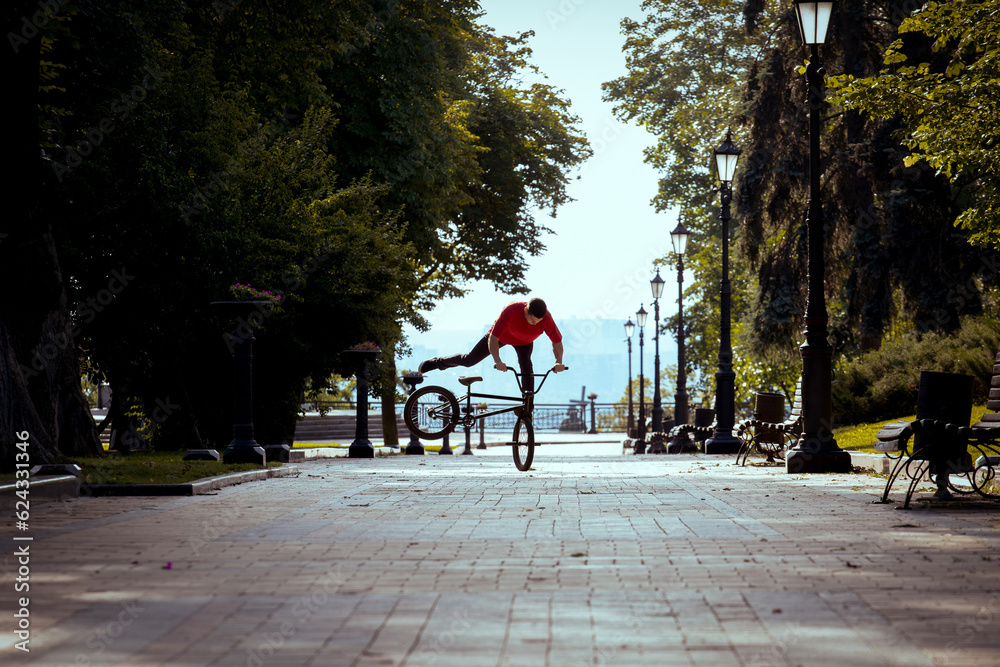 Ukrainian bmx rider performs tricks in the middle of the city.