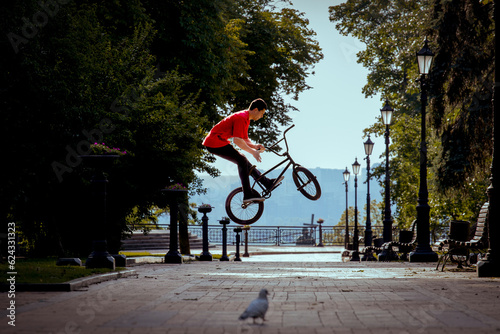 Ukrainian bmx rider performs tricks in the middle of the city.