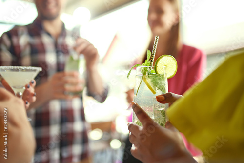 Wall Mural Close-up of female hand holding glass with drink, mojito